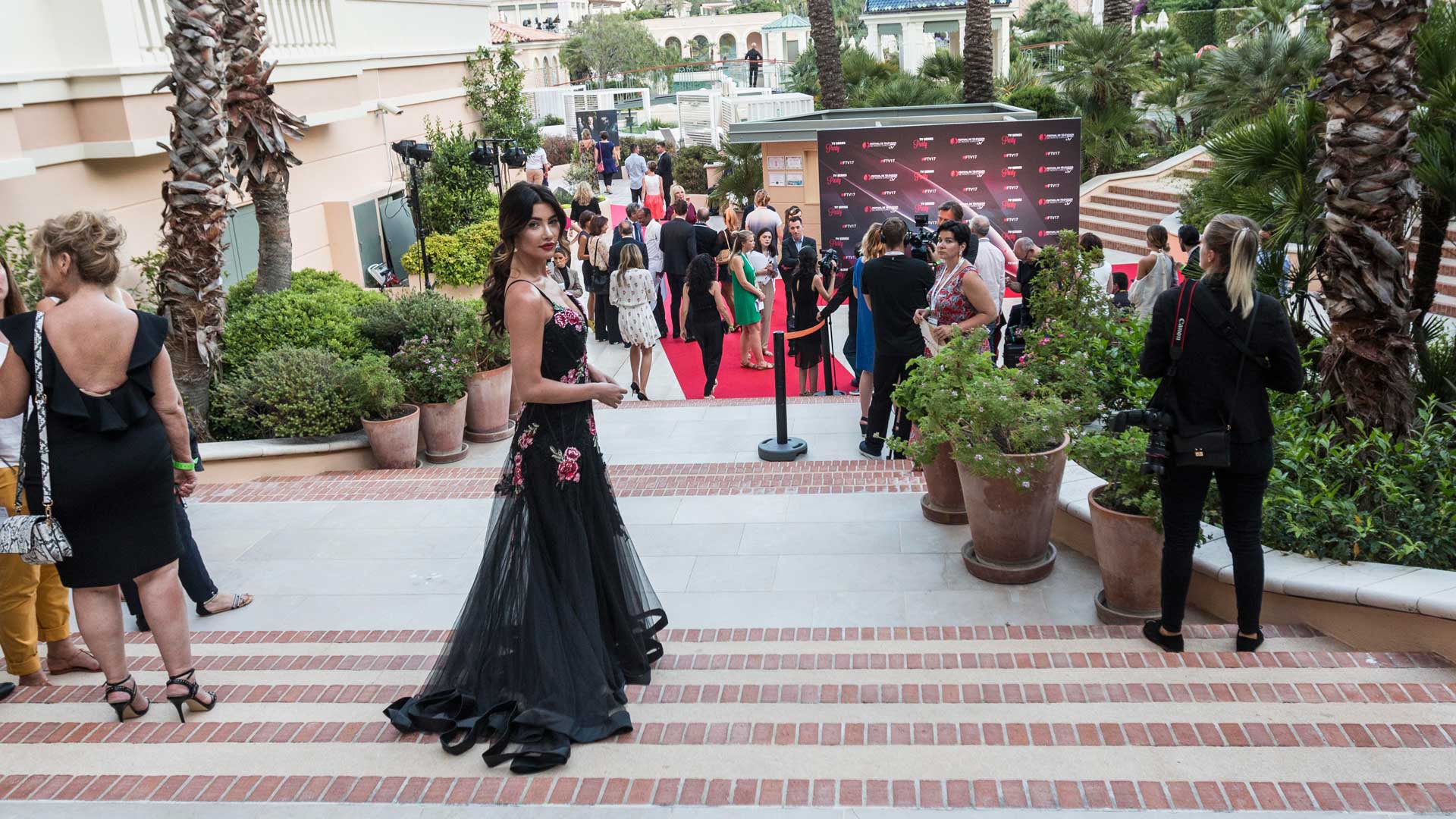 In a gorgeous black gown with floral appliques, Jacqueline MacInnes Wood makes her way into the Monte Carlo TV Festival's Pool Party.