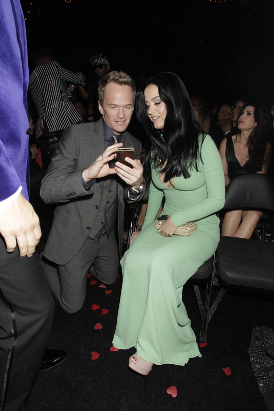 (2013) We’re wondering what Katy and Neil Patrick Harris are tweeting about. Please let it be us. (Photo by: Corbis)