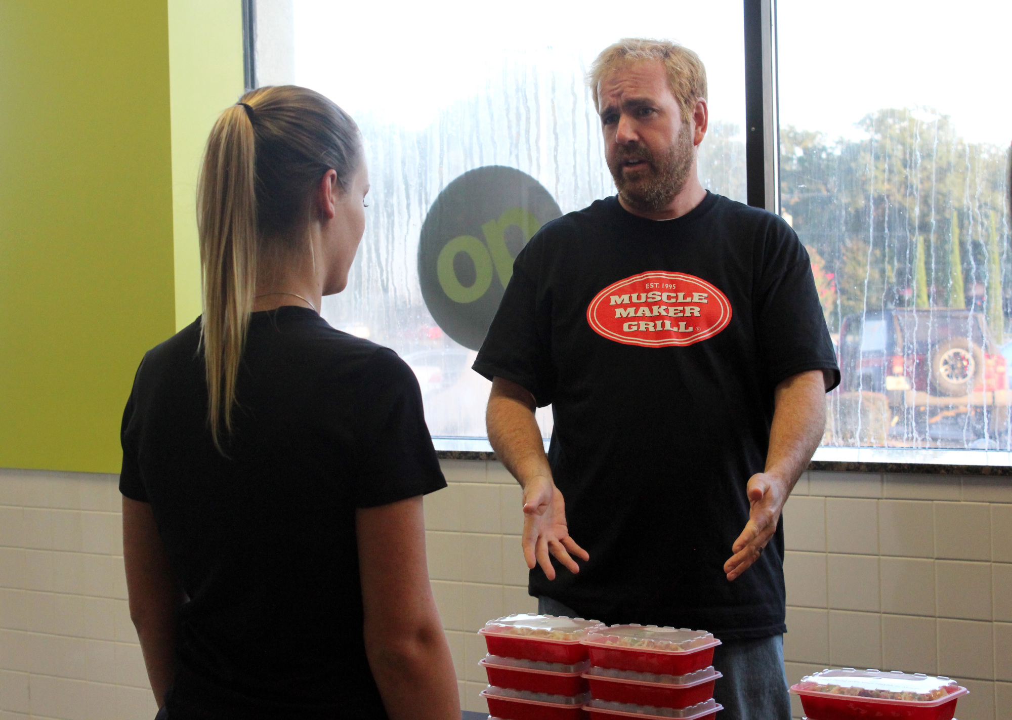 Tim learns about Muscle Maker Grill's meal-plan program. 