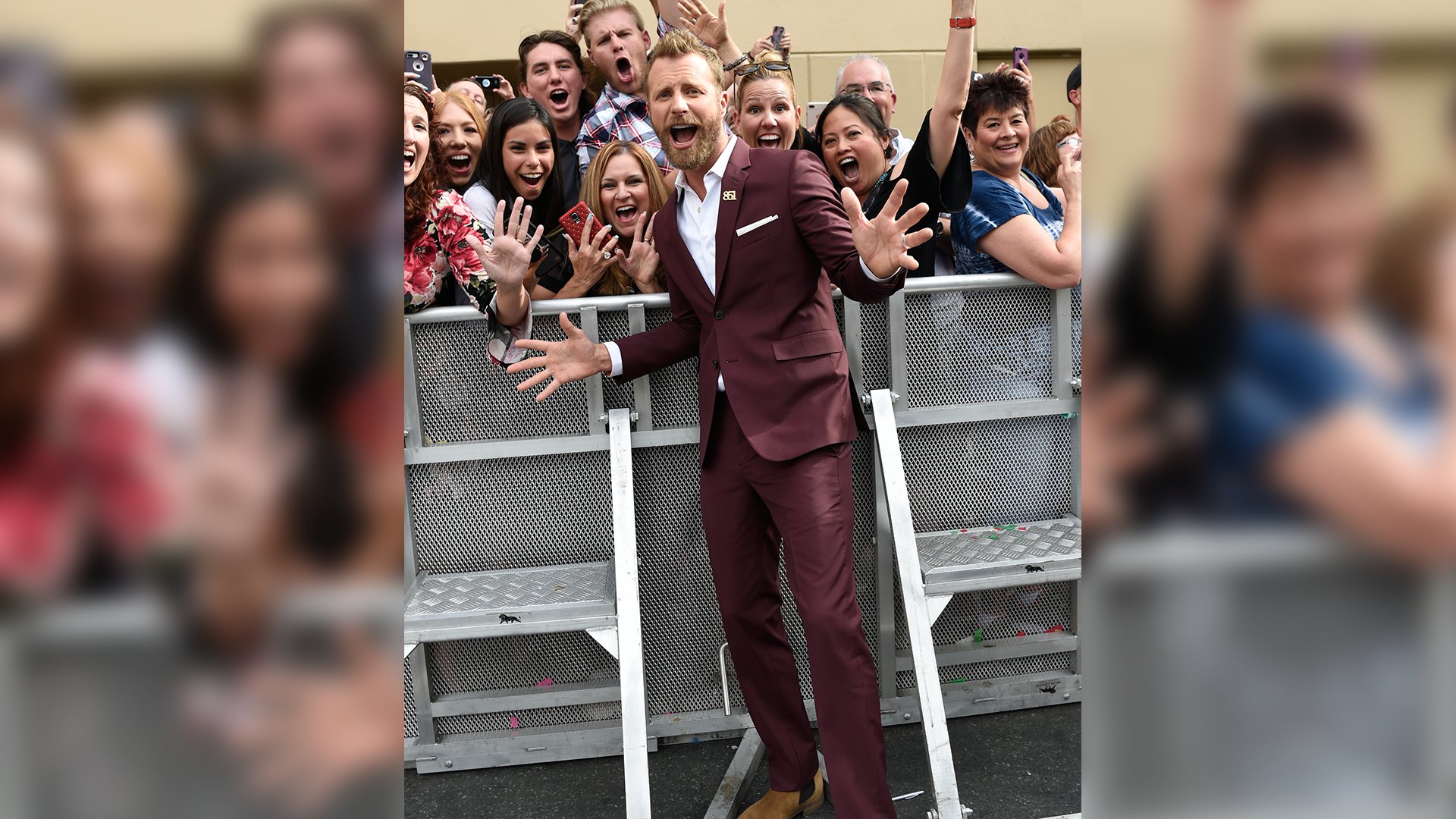Dierks Bentley can't help but bust out a couple jazz hands while posing with eager fans.