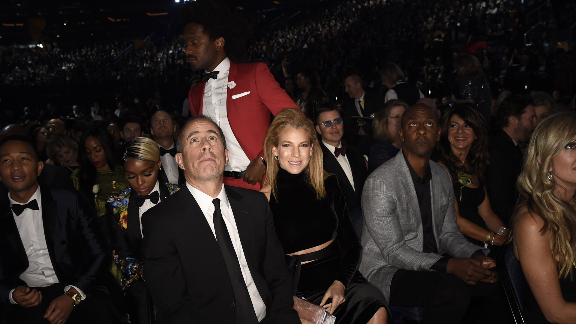 Comedian and 2018 GRAMMY nominee Jerry Seinfeld looks up, while his wife, Jessica, gives the camera a big grin. 