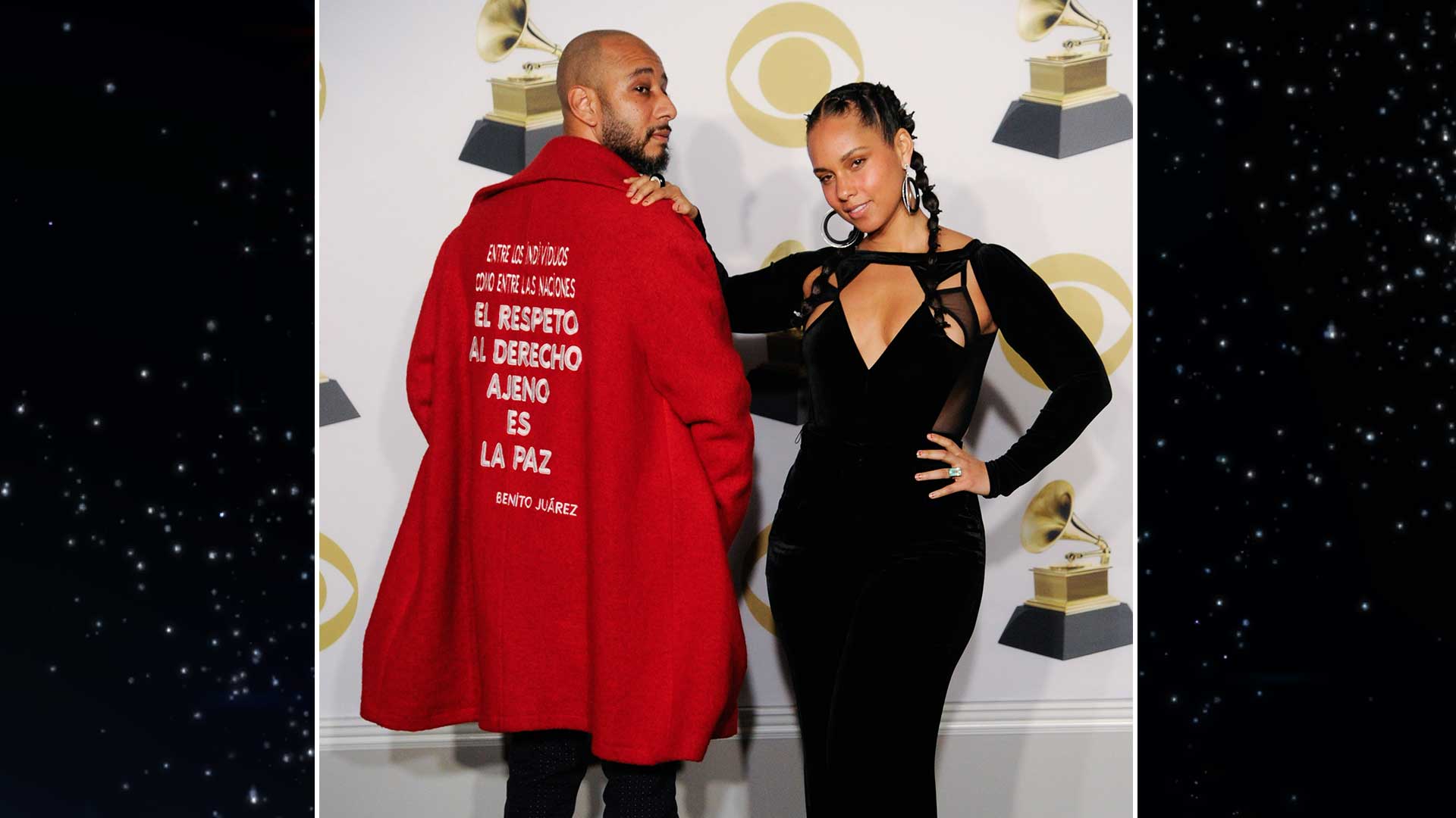 Alicia Keys puts her hand on her husband Swizz Beatz's shoulder as they pose in the GRAMMY press room.