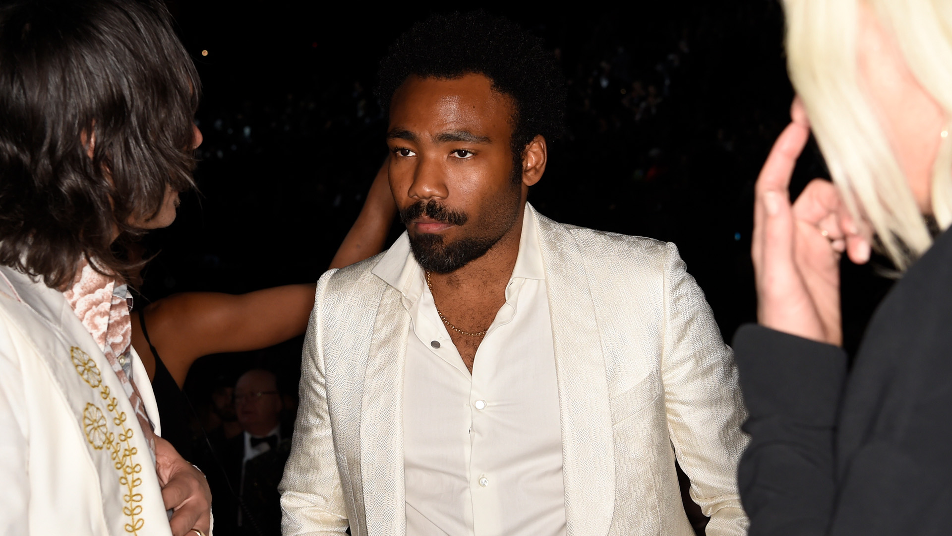 Best Traditional R&B Performance winner and GRAMMY performer Childish Gambino looks on in a crisp white suit.