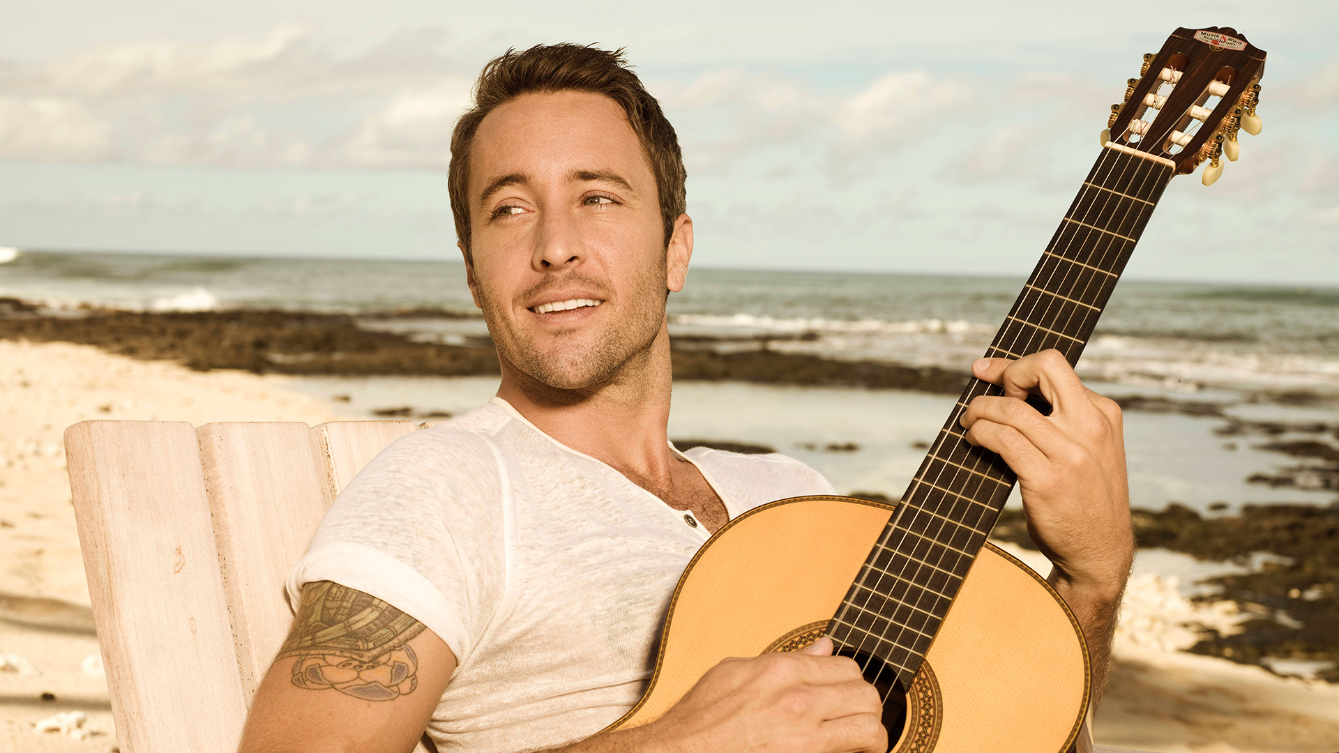 Nothing says spring great like Alex O'Loughlin strumming a guitar on the shore