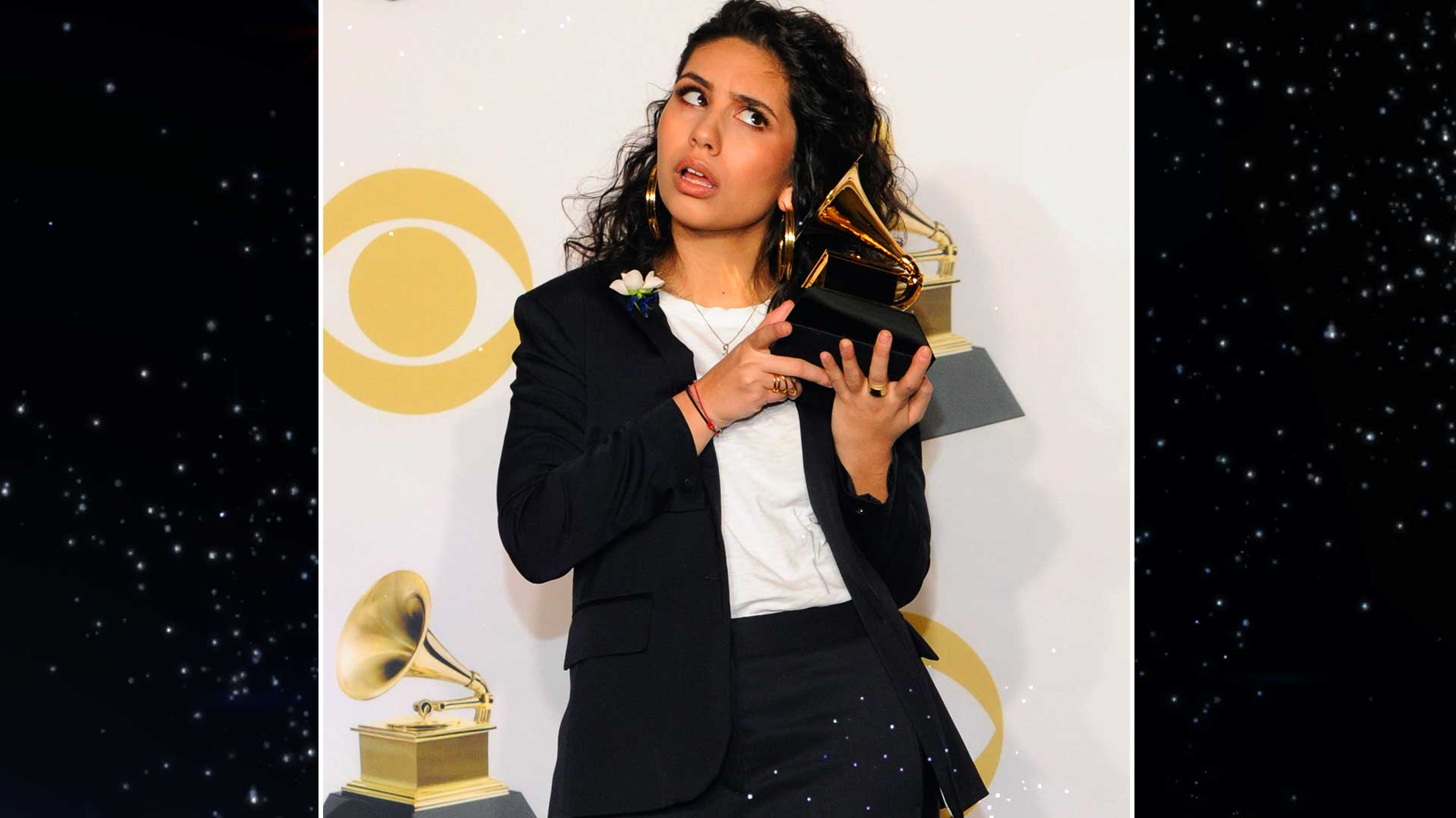 Best New Artist winner Alessia Cara holds her newly won GRAMMY to her ear backstage.