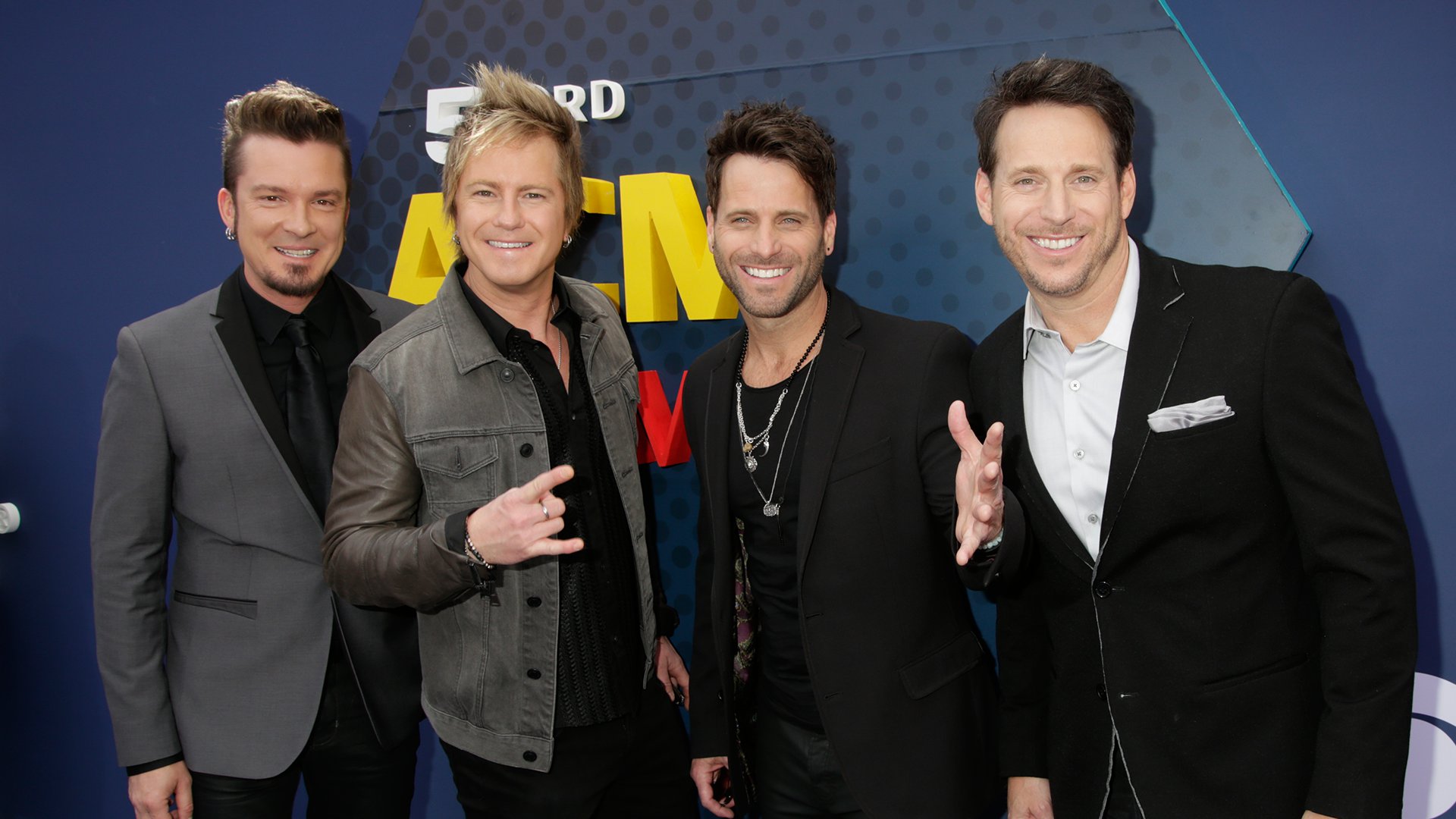 The members of Parmalee wear a variety of different textures on the red carpet, including velvet and denim.