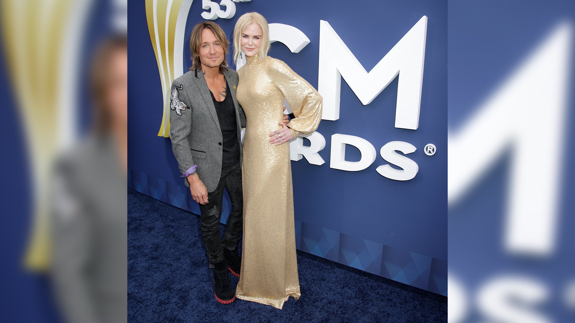 Keith Urban poses with wife Nicole Kidman, who looks statuesque in a floor-length gold gown.