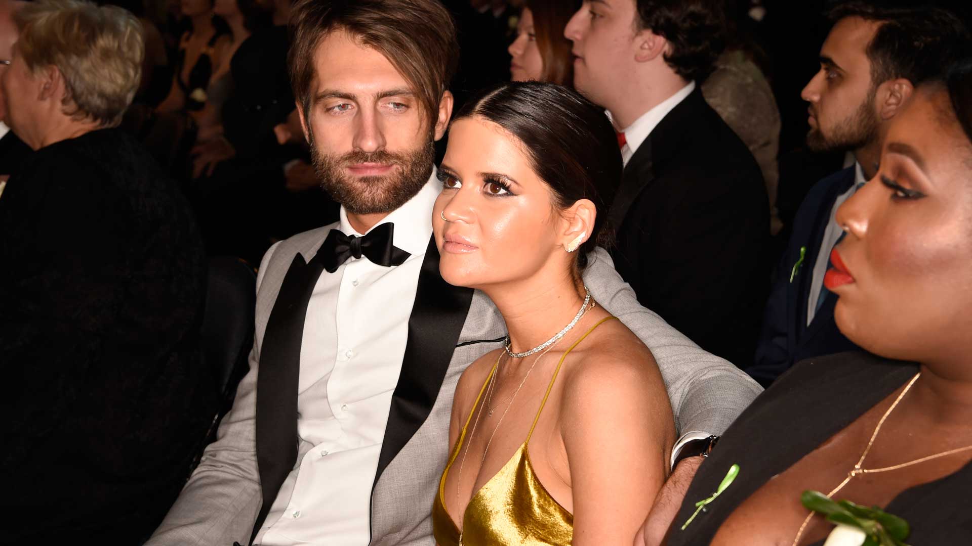 Country songstress and GRAMMY performer Maren Morris takes her seat beside her fiancé, Ryan Hurd.