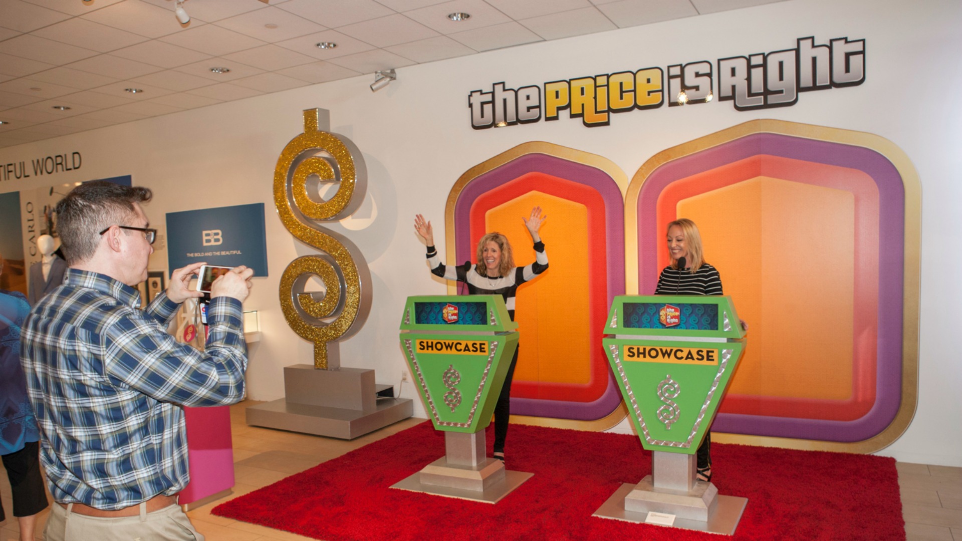 Two fans check out The Price Is Right Showcase podiums.