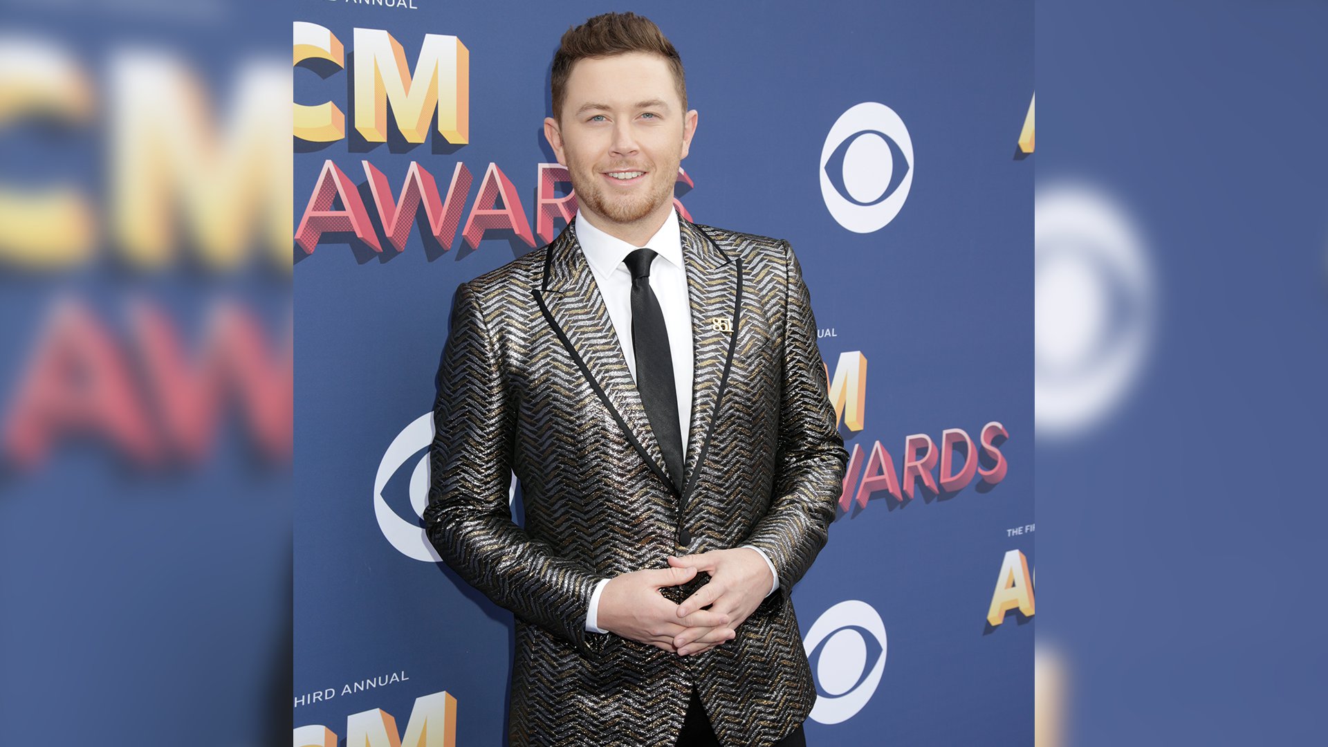 Singer Scotty McCreery looks all grown up in his gold herringbone jacket and black-piped lapel.