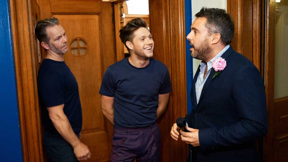 Niall Horan's bodyguard (left) is about to toss Louis Waymouth (right) outside.