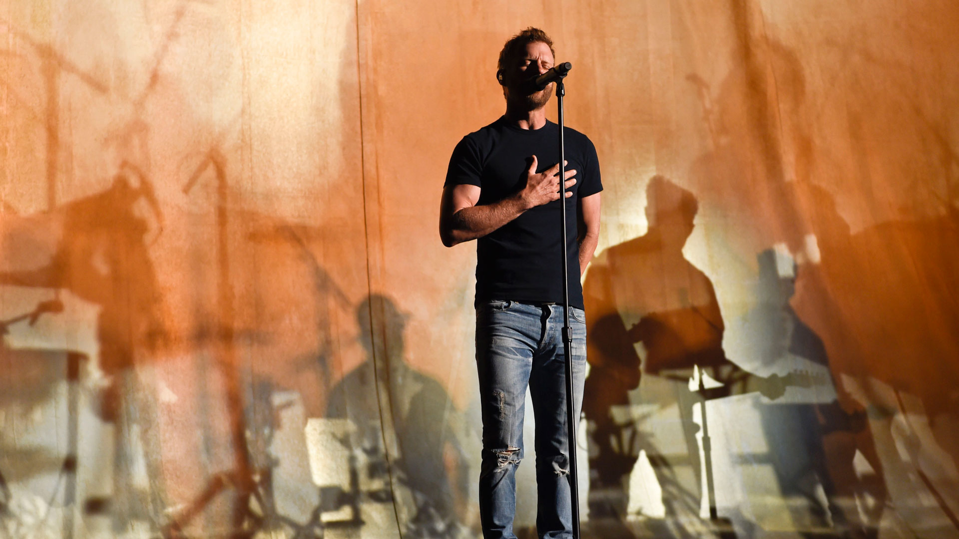 Dierks Bentley puts his hand on his chest during rehearsals for 