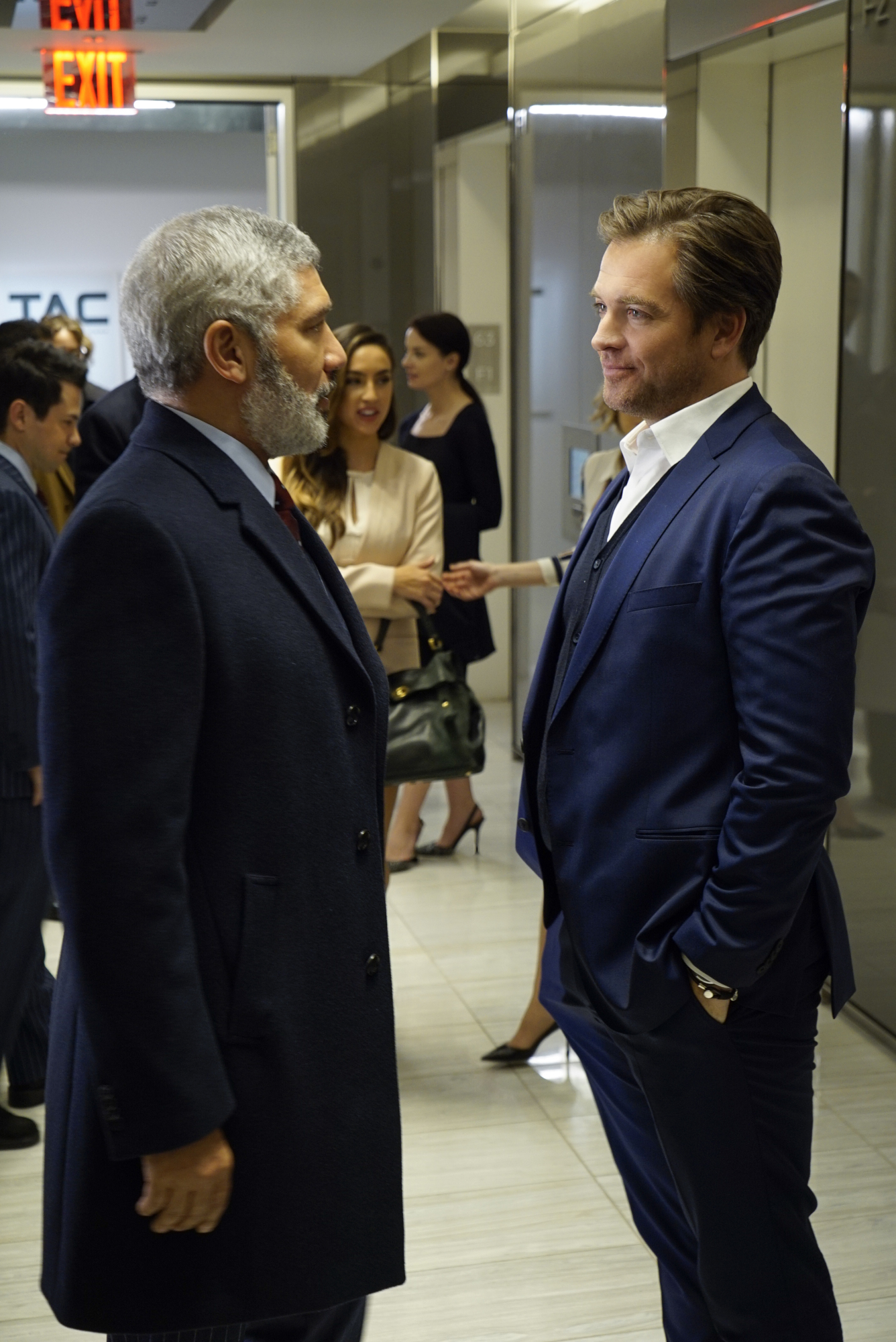 Dr. Bull meets with his client's lawyer in the hallway.