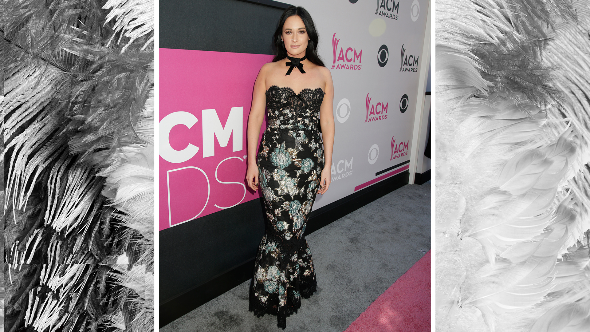 Kacey Musgraves poses on the red carpet in a gorgeous floral gown with lace accents.