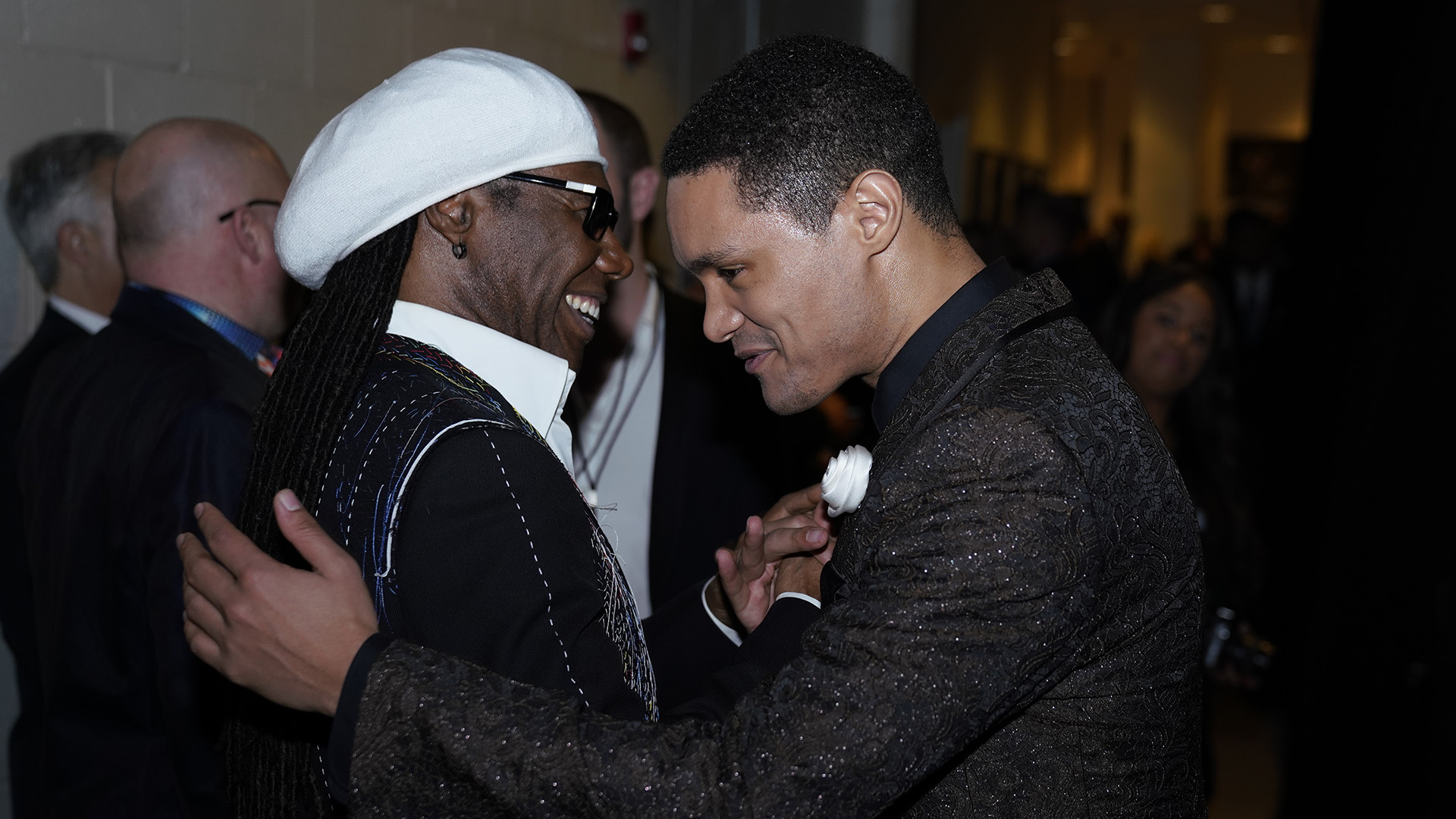Comedian and GRAMMY presenter Trevor Noah gets a hug from funk legend Nile Rodgers.