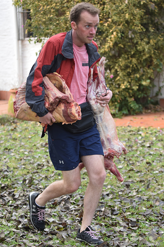 James Earl Corley (#TeamAlabama) carries meat from La Porteña to his work station.