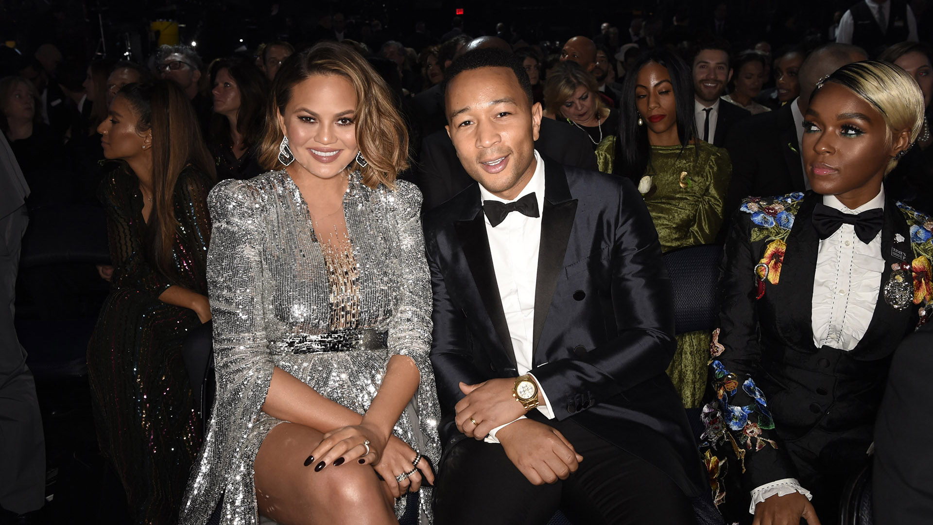Soul-pop crooner John Legend offers a smile for the camera alongside wife Chrissy Teigen, while Janelle Monáe looks on.