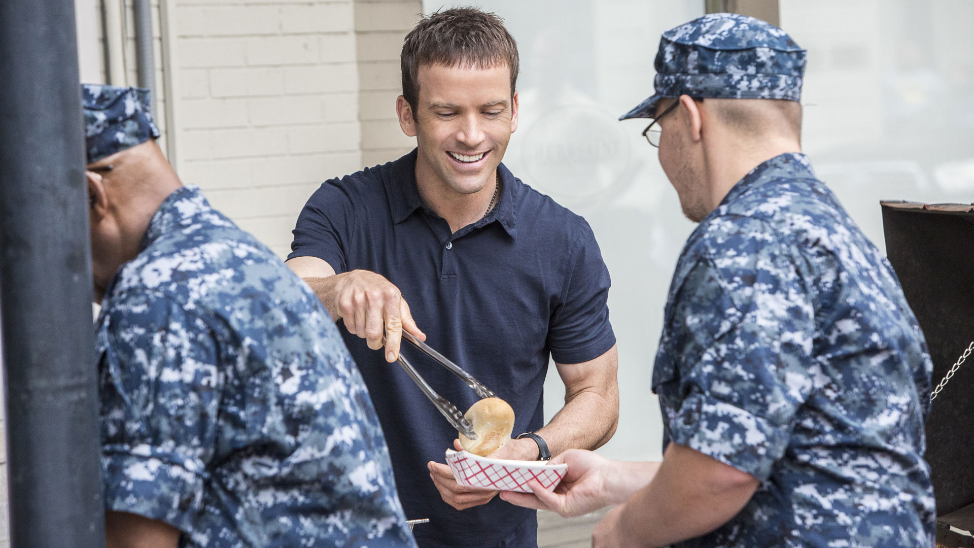 Lasalle serves food to military personnel.