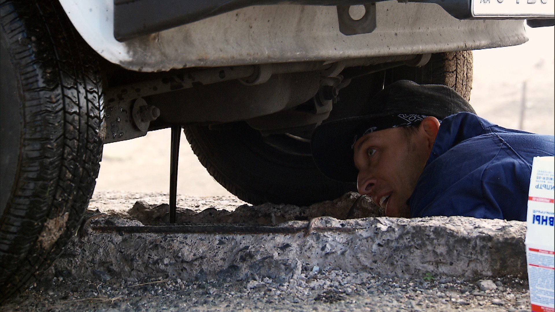Matt does whatever it takes to change the oil on this stationary taxi.