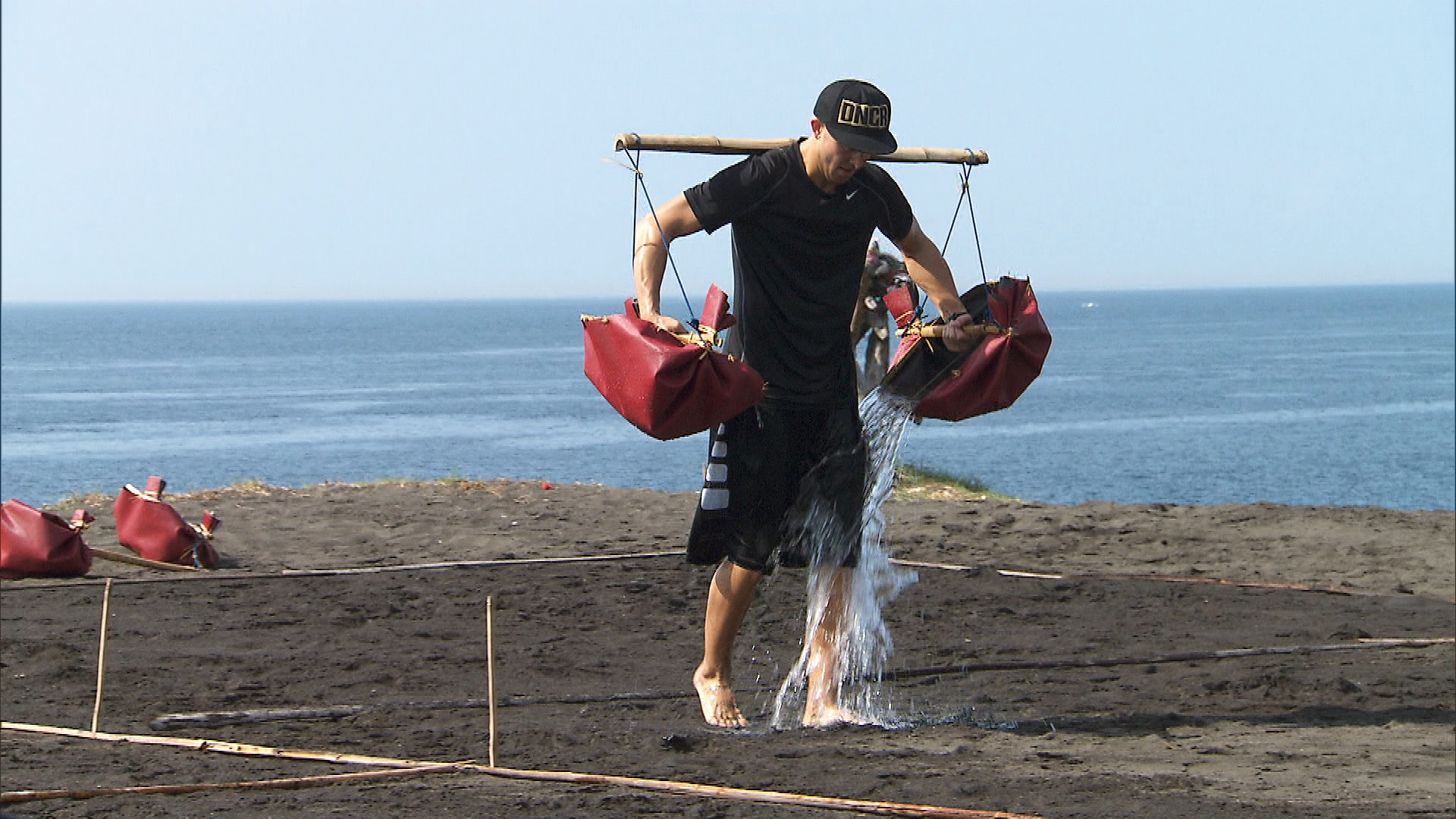 Matt helps a Balinese salt farmer by carrying water from the ocean.