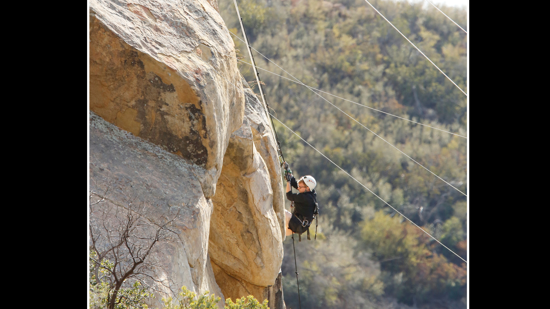 Tyler tries climbing the side of a mountain to retrieve his half of the next clue.